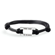 Bracelet cordon noir avec plaque acier inoxydable gravée « Baby Jack » et date « 02.19.2022 ».