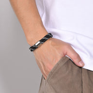 Bracelet cordon noir pour homme à rayures blanches avec fermoir métallique argenté.