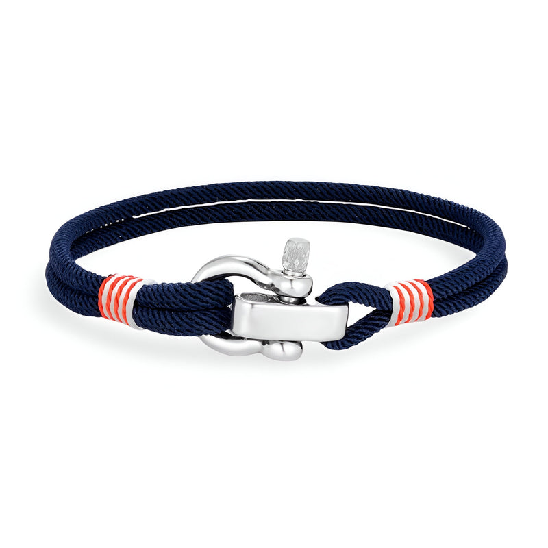Bracelet cordon bleu marine avec manille en acier inoxydable et détails rouges et blancs.