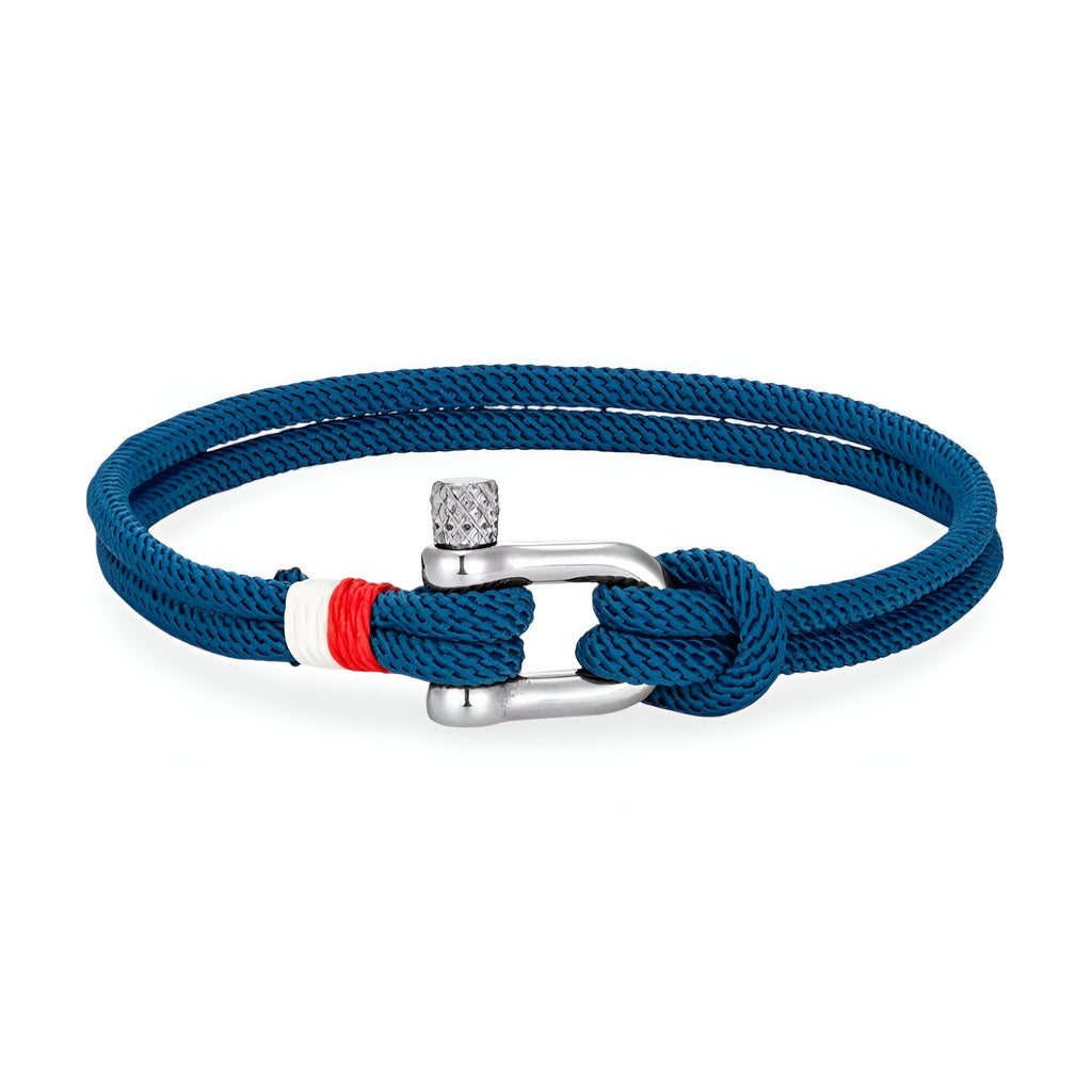 Bracelet cordon bleu marine avec manille en acier inoxydable et détail rouge et blanc.