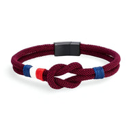 Bracelet cordon bordeaux avec noeud et détails tricolores bleu blanc rouge, fermoir noir mat.