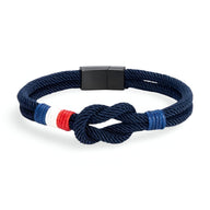 Bracelet cordon bleu marine avec noeud et détail drapeau français rouge, blanc, bleu, fermoir noir mat.