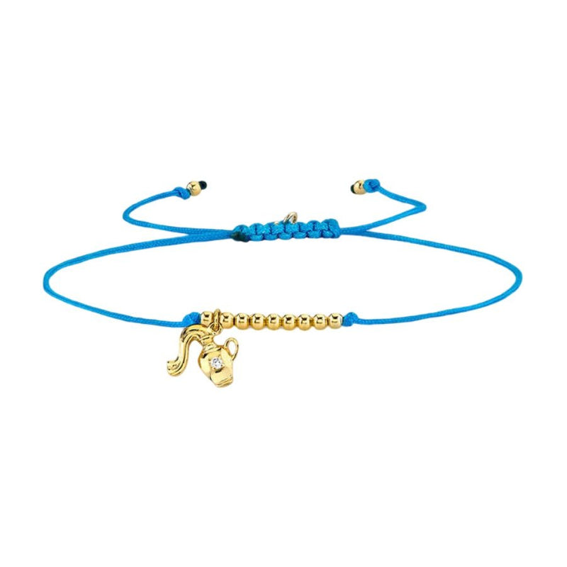 Bracelet cordon bleu avec breloques signe astrologique Bélier en métal doré et perles dorées ajustable.