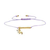 Bracelet cordon violet avec perles dorées et pendentif bélier doré élégant.