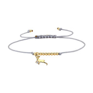 Bracelet cordon gris avec perles dorées et pendentif signe du zodiaque Bélier en métal doré.