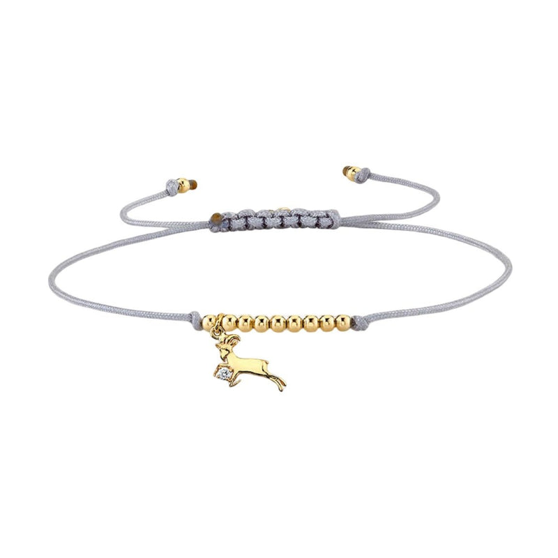 Bracelet cordon gris avec perles dorées et pendentif signe du zodiaque Bélier en métal doré.