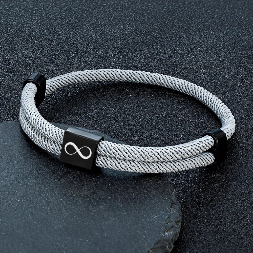 Bracelet cordon gris argenté avec plaque noire en acier inoxydable gravée d’un signe infini.