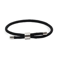 Bracelet cordon noir simple avec fermoir cylindrique métallique argenté.
