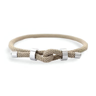 Bracelet cordon beige noué avec éléments métalliques argentés pour homme.