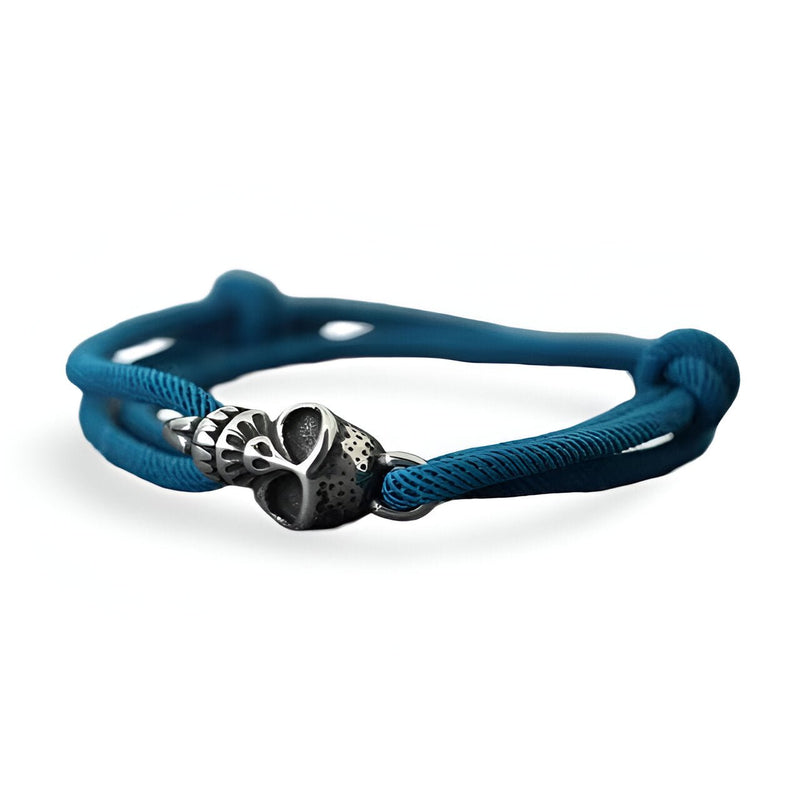 Bracelet bleu marine en cordon avec tête de mort métallique stylisée pour homme.
