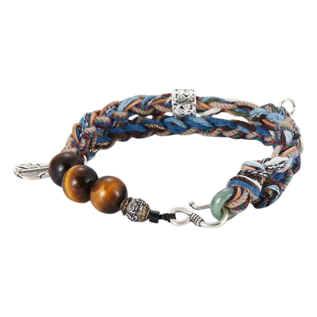Bracelet cordon tressé bleu, marron et beige avec perles œil de tigre, jade verte, breloques dragon et plume métal, fermoir.