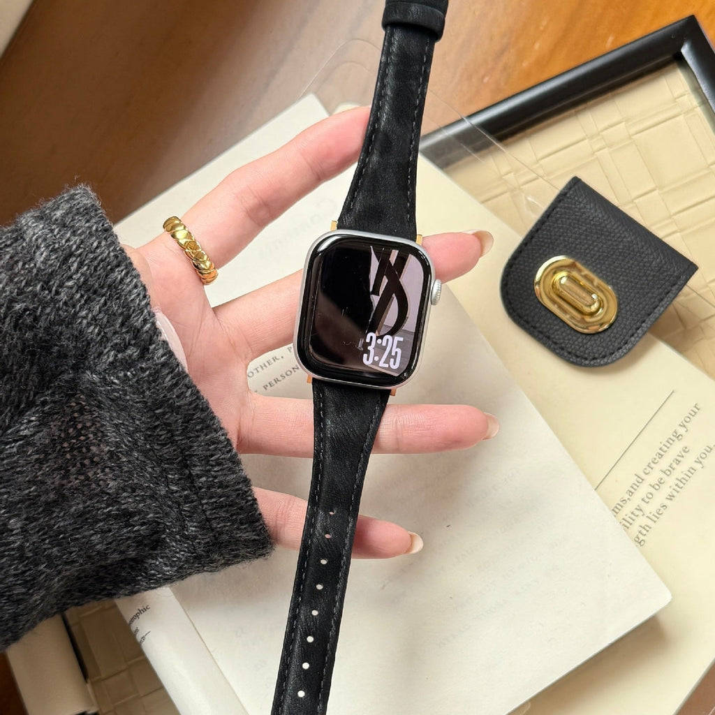 Bracelet en cuir noir texturé avec boucle dorée pour Apple Watch, style élégant et fin.
