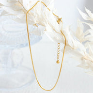 Bracelet de cheville en acier inoxydable doré à maille serpent délicate avec chaîne réglable.