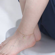 Bracelet de cheville doré fin avec pendentifs coquillage et étoile de mer en argent sterling.