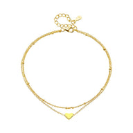 Bracelet de cheville doré en argent sterling avec petit pendentif cœur fin et chaîne fine double rang.