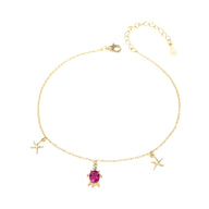 Bracelet de cheville en argent avec pendentif tortue et étoiles de mer, pierre rouge centrale.