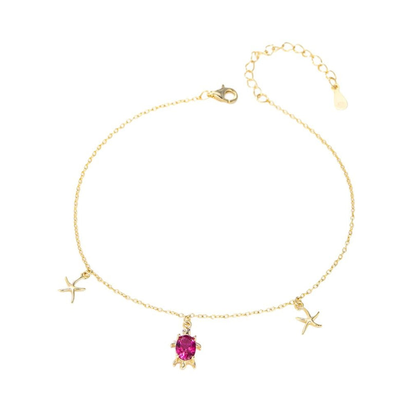Bracelet de cheville en argent avec pendentif tortue et étoiles de mer, pierre rouge centrale.