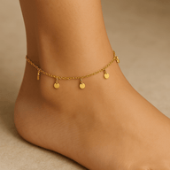 Bracelet de cheville en titane doré avec plusieurs petits médaillons ronds pendants.