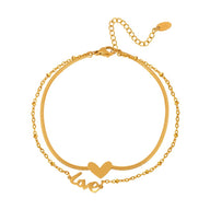Bracelet de cheville doré en titane avec pendentifs cœur et lettrage "love" délicat.