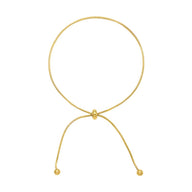 Bracelet de cheville coulissant en titane doré avec embouts ronds brillants.