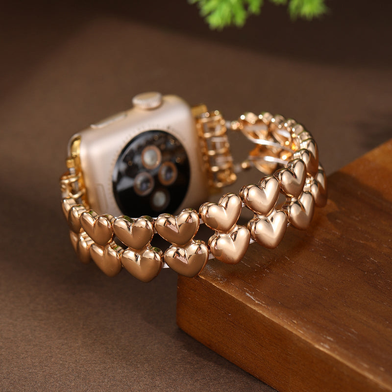 Bracelet Apple Watch doré à motif cœurs brillants, design féminin et élégant, modèle Fabiola.