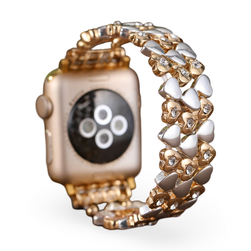 Bracelet Apple Watch or rosé avec motif cœurs entrelacés en métal lisse et poli, taille 38 à 42 mm.