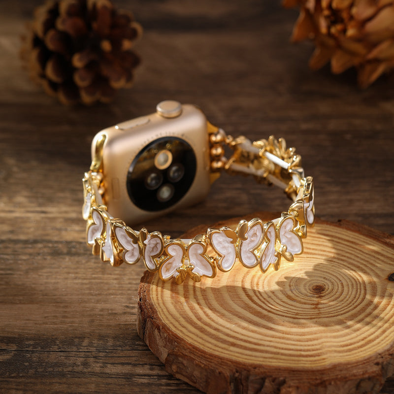 Bracelet Apple Watch doré à motif papillons blancs, style élégant et féminin, modèle Florencia.