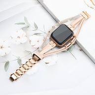 Bracelet Apple Watch rose à strass avec maillons métalliques, design élégant pour femme.