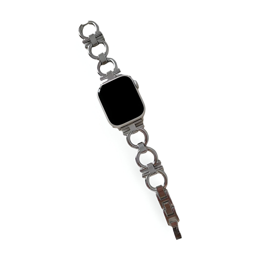 Bracelet circulaire en métal argenté pour Apple Watch avec maillons larges et fermoir robuste.