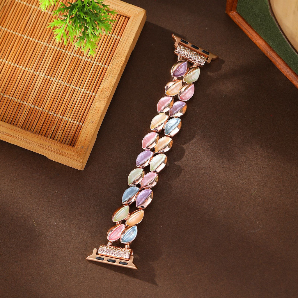 Bracelet Apple Watch femme modèle Raquel avec pétales scintillants multicolores et attache rose.