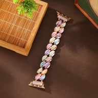 Bracelet Apple Watch femme modèle Raquel avec pétales scintillants multicolores et attache rose.