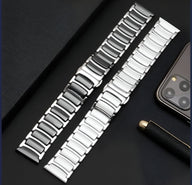 Bracelet Apple Watch en acier inoxydable noir et argent, maillons larges et finition brillante.