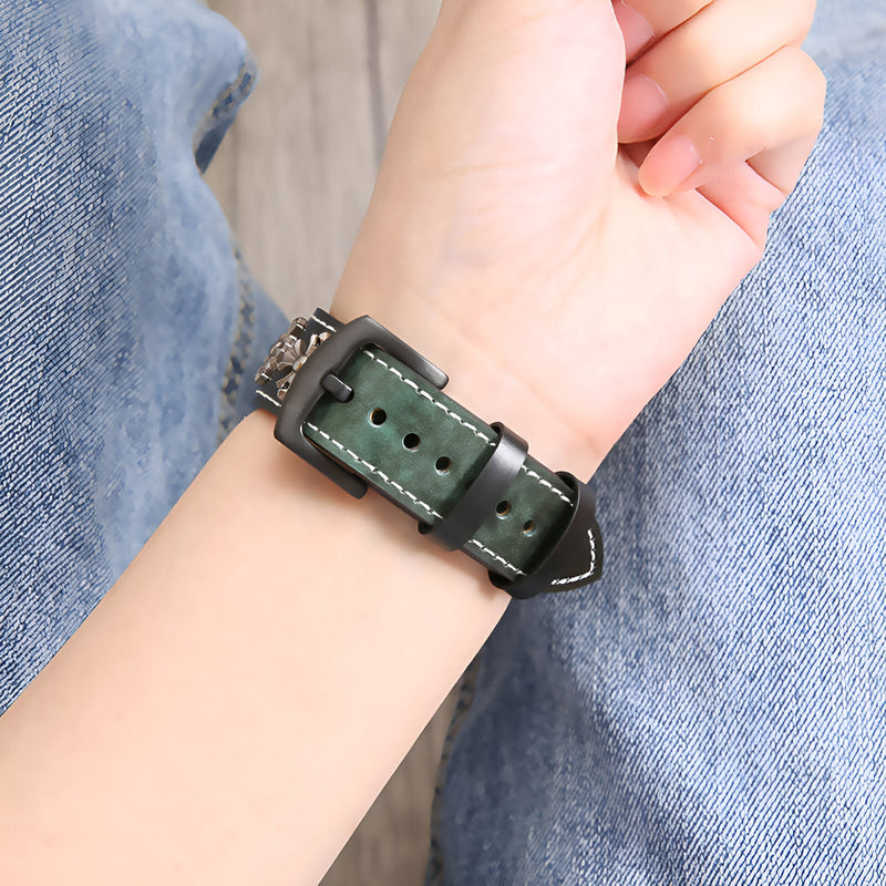 Bracelet Apple Watch en cuir vert kaki avec rivets et boucle noire sur poignet.