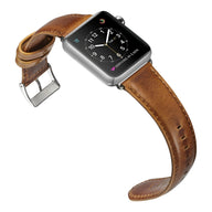 Bracelet de montre Apple en cuir marron patiné avec boucle argentée, style classique pour homme.