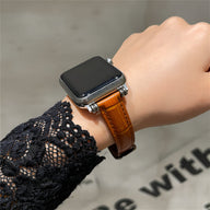 Bracelet Apple Watch en microfibre marron avec texture imitant le cuir sur poignet féminin.