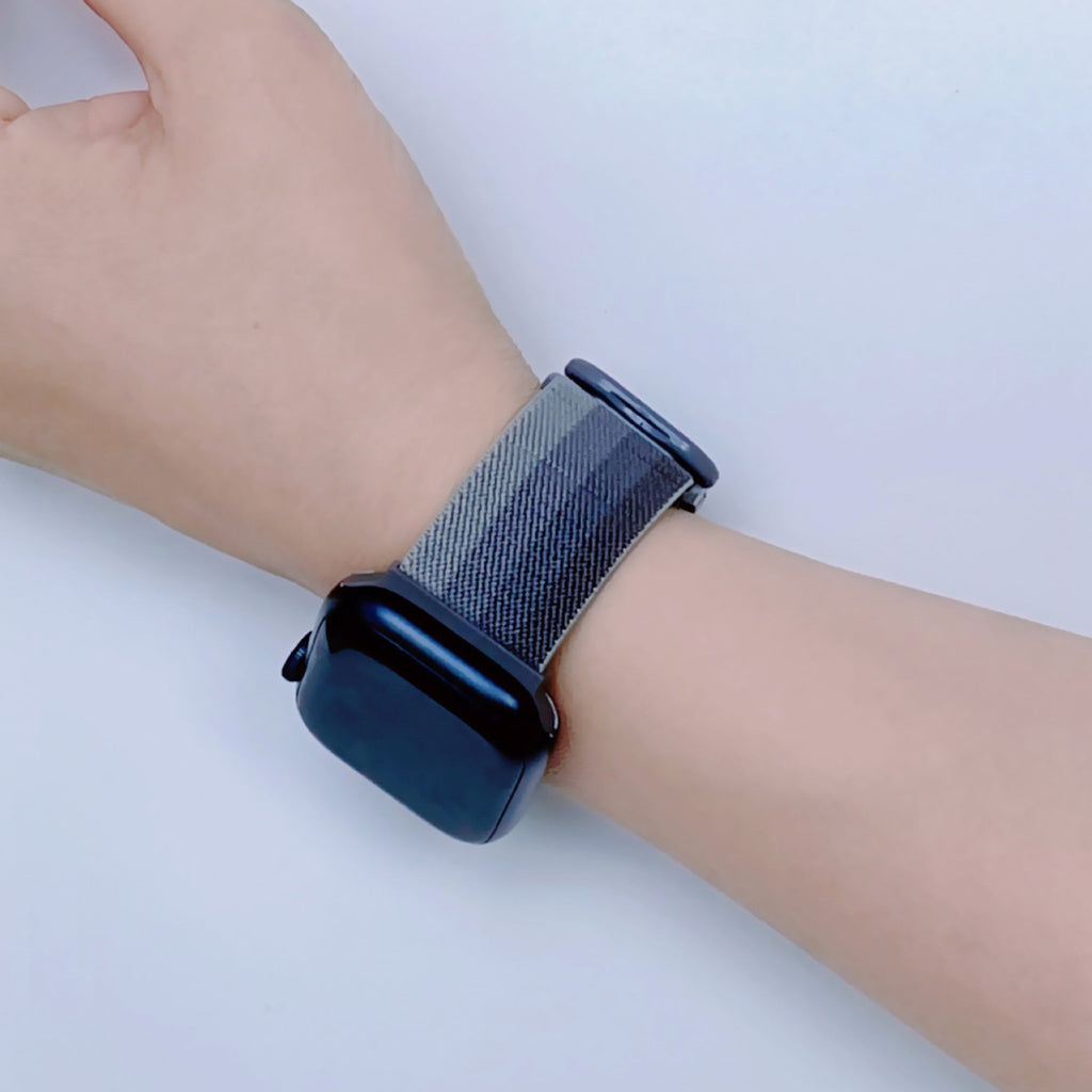 Bracelet Apple Watch en nylon gris dégradé, style Fenix, porté au poignet, taille moyenne.