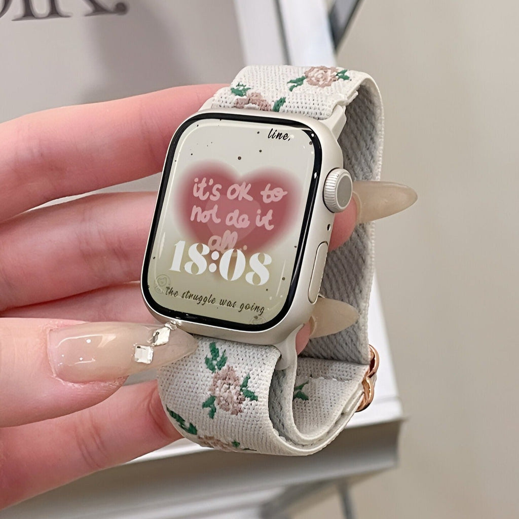 Bracelet Apple Watch en nylon blanc avec motifs floraux roses et verts, modèle Elexia.