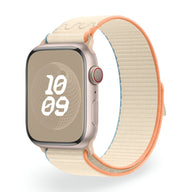 Bracelet Apple Watch en nylon beige clair avec bordure orange vif, style sport et boucle Velcro.