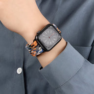 Bracelet Apple Watch en nylon orange, noir et gris tressé, taille adaptable, style mixte.