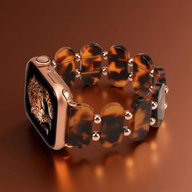 Bracelet Apple Watch en résine marron translucide style sauvage avec maillons ovales et détails dorés.