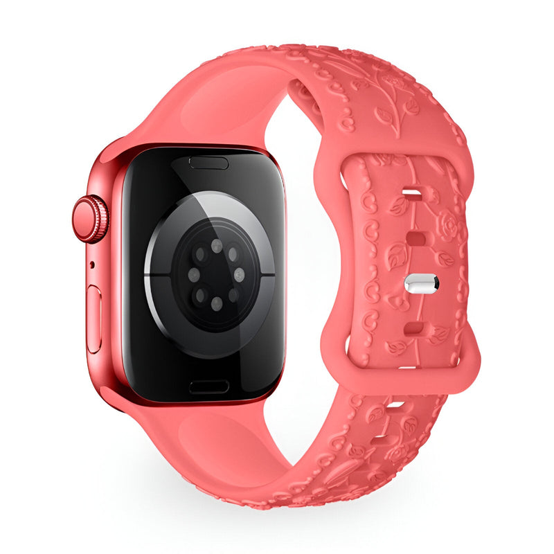 Bracelet Apple Watch en silicone rouge corail avec motif floral embossé, boucle ajustable.