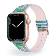 Bracelet Apple Watch en silicone pailleté bleu et vert avec intérieur rose pâle et boucle or rose.