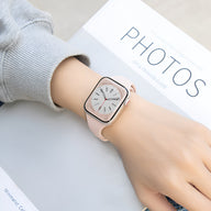 Bracelet silicone rose saumon pour Apple Watch, modèle Kairo, porté au poignet féminin.