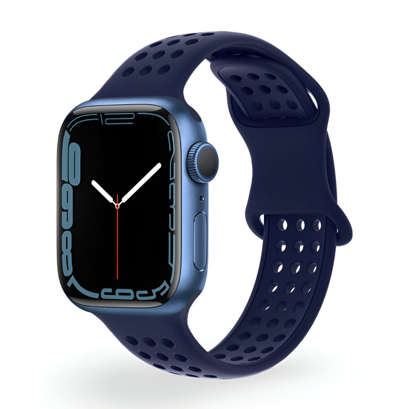 Bracelet Apple Watch silicone bleu marine perforé, design sport pour femme, fermeture ajustable.