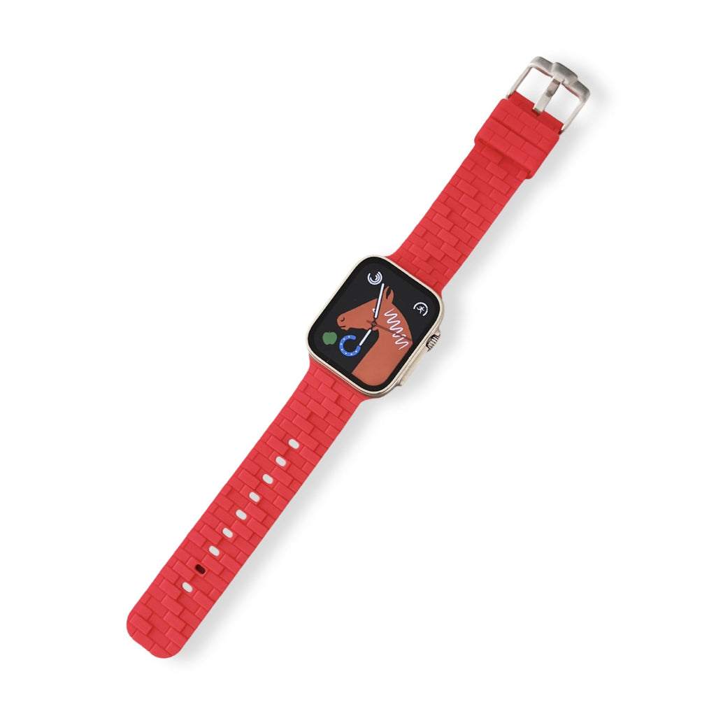 Bracelet Apple Watch en silicone rouge style brique avec boucle métallique argentée.