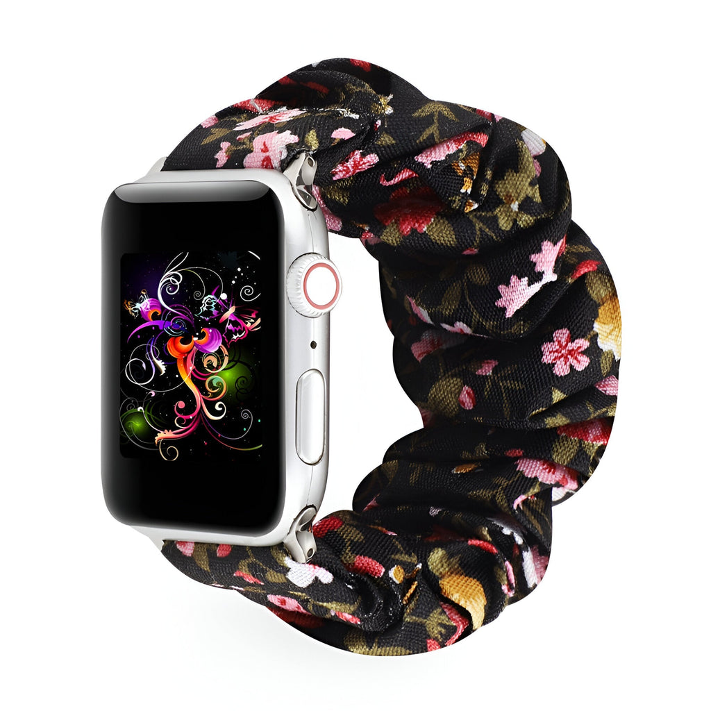 Bracelet pour Apple Watch en tissu élastique noir à motif floral rose et beige.