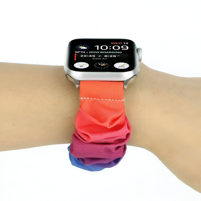 Bracelet élastique pour Apple Watch femme, tissu dégradé orange à violet, style scrunchie.