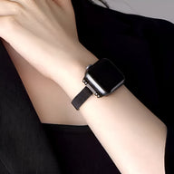 Bracelet Apple Watch maille milanaise noir ajusté poignet femme, style élégant et moderne.
