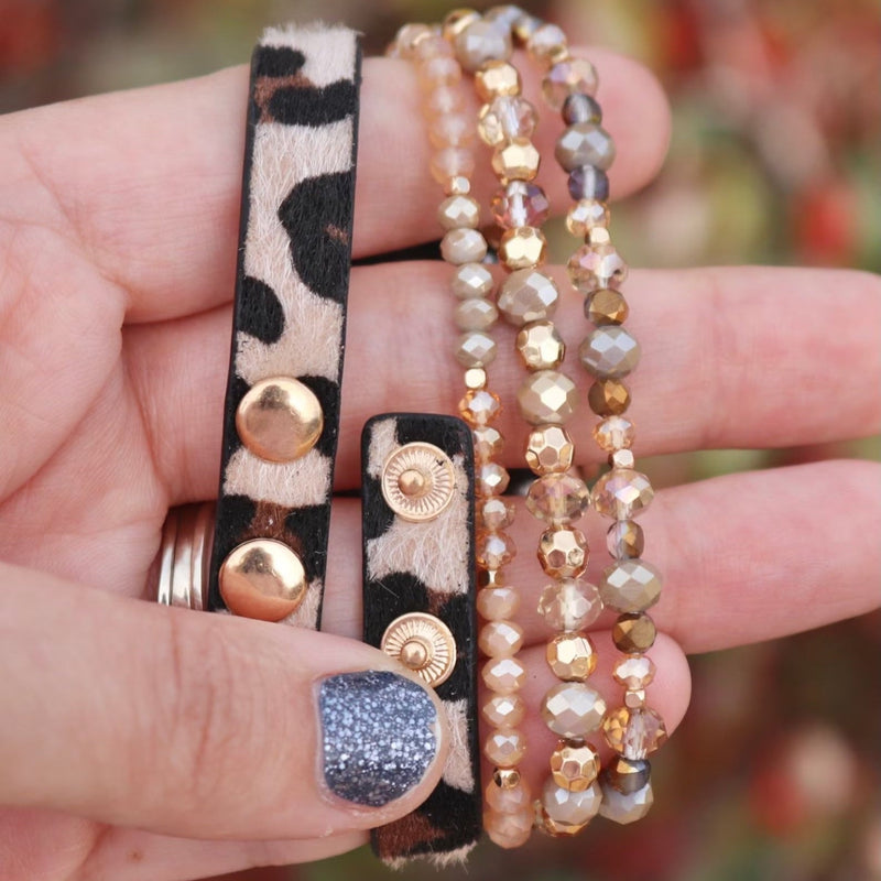 Bracelet Apple Watch multi-rangs perlé léopard noir et beige avec boutons dorés, style Malia pour femme.