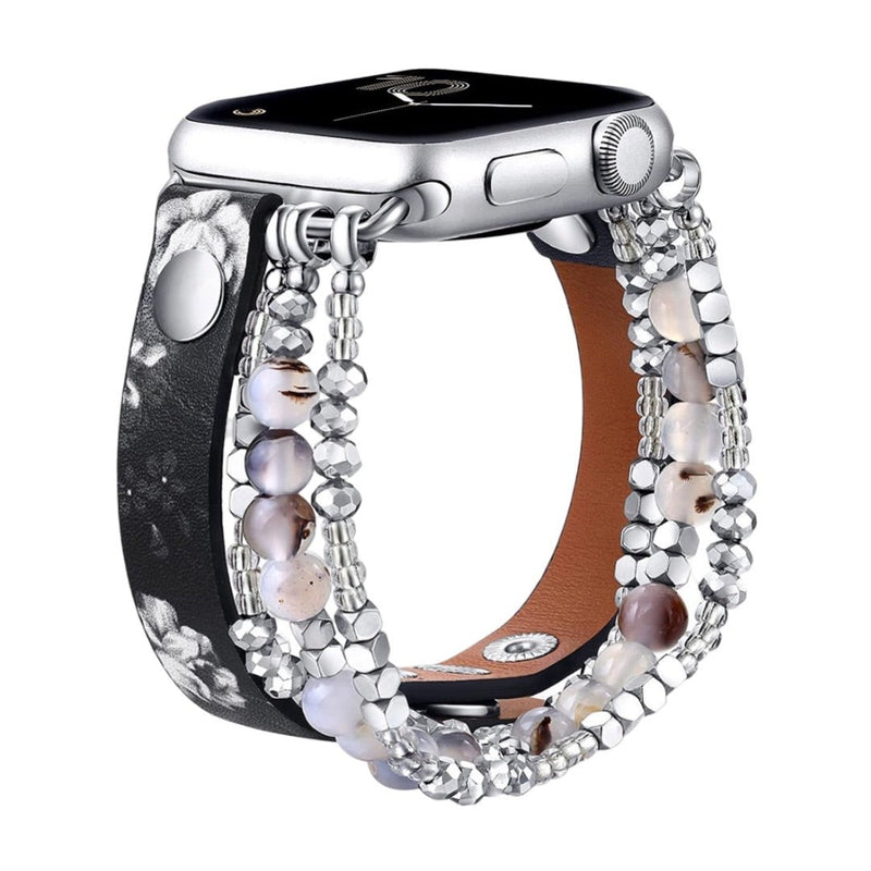 Bracelet Apple Watch multi-rangs perlé noir avec détails léopard et intérieur en cuir camel.